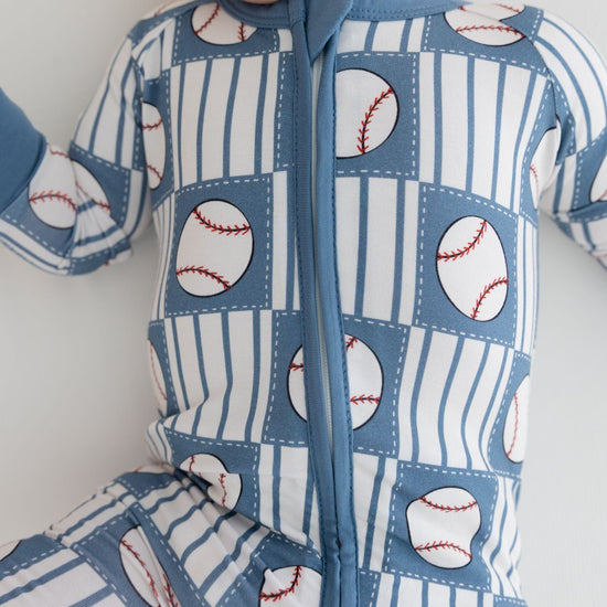 Baby onesie with baseball pattern on a white background