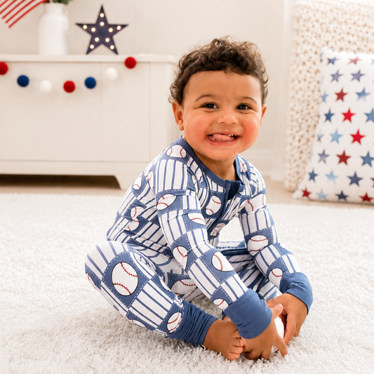 Child wearing blue baseball zippy romper.