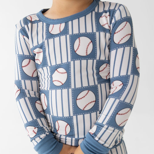 Children's pajama set with baseball pattern on a white background