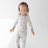 Child wearing American Flag PJs featuring blue accents and blue bows.