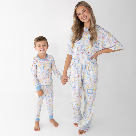 A woman and a young boy wearing matching pajama sets that have blue and white patterned featuring silly gooses in a beach theme with watermelon, beach theme and palm trees.