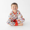 Child wearing pajamas with a chicken nugget pattern on a white background