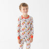 Child wearing a colorful pajama set with chicken nugget design on a white background