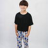 Child wearing a black t-shirt and patterned pants sports-themed design on a white background featuring Duke University Basket ball, basket ball hoop, basket ball, Duke Jersey, Stars.