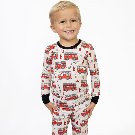 Toddler wearing fire truck two piece long sleeve pajamas 
