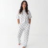 Photo shows a woman standing with her hands in her pockets wearing Monkeeroos Mallards Women's Lounge Set. Its a light background with blue trim and has mallard ducks all over it.