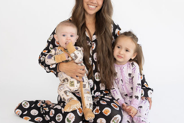 Mom with 2 kids in Halloween pajamas